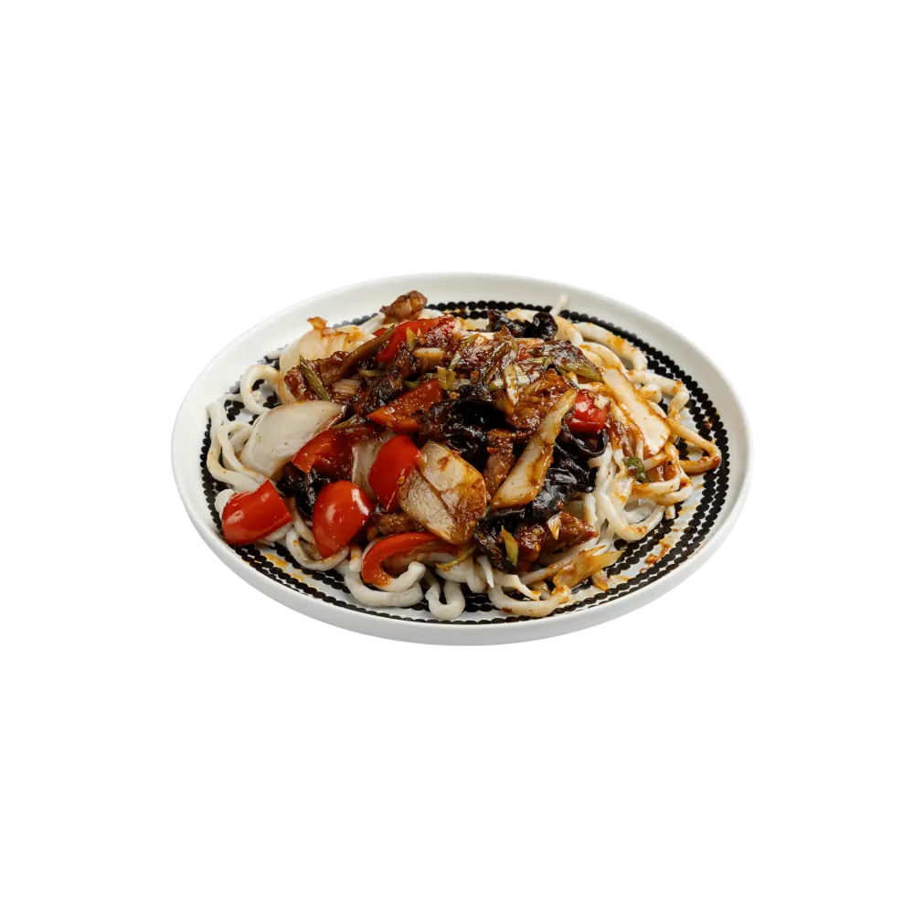 Classic Uyghur leghmen noodles with beef, bell peppers and vegetables on a patterned plate