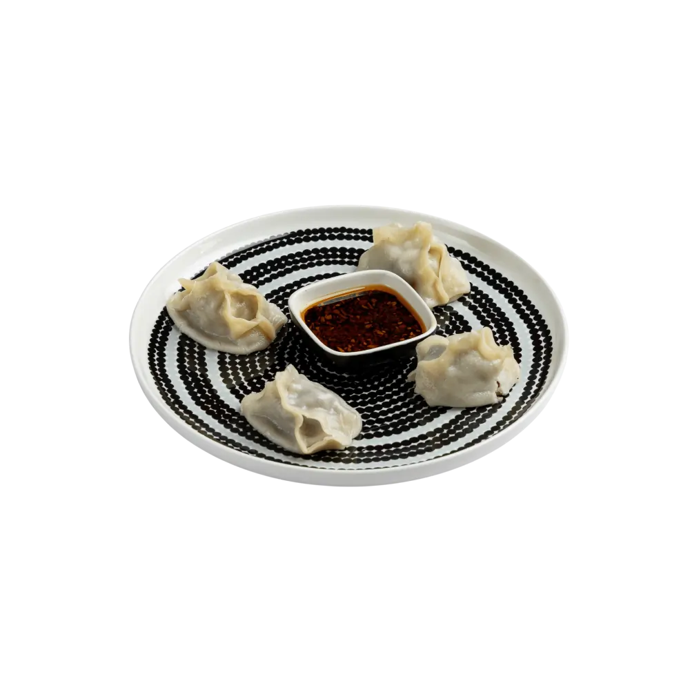 Steamed Uyghur dumplings served with spicy dipping sauce 
