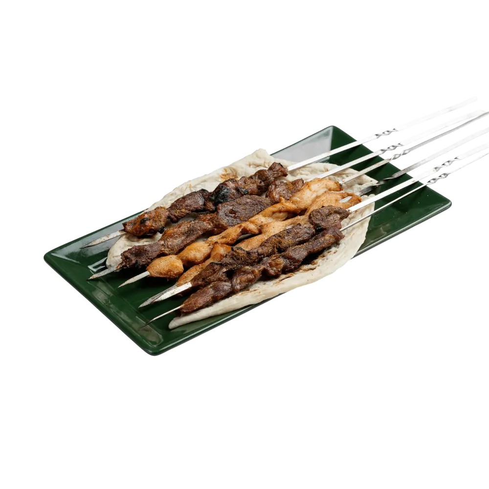 Grilled lamb and chicken shish kebab skewers on flatbread 