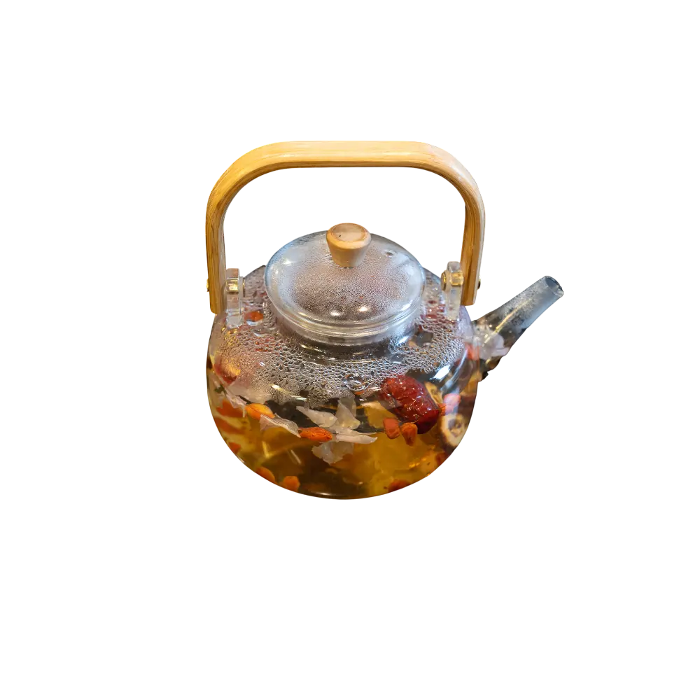 Glass teapot of hot Uyghur herbal tea with berries and flowers at Leghmenchi restaurant